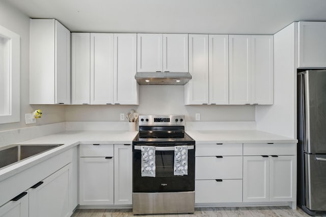 2034 Wilder Dr, Redding, CA 96002 - kitchen with stainless steel appliances, under cabinet range hood, white cabinetry, light countertops, and a sink