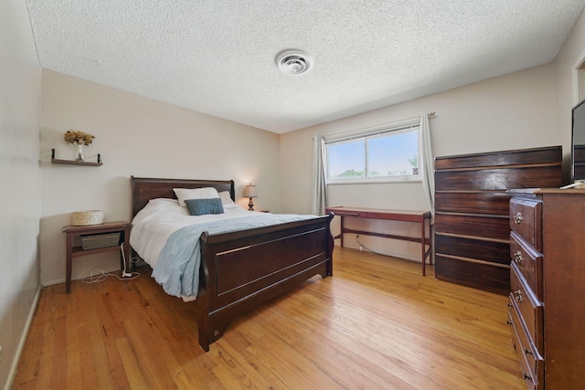2034 Wilder Dr, Redding, CA 96002 - bedroom with light wood-type flooring and a textured ceiling