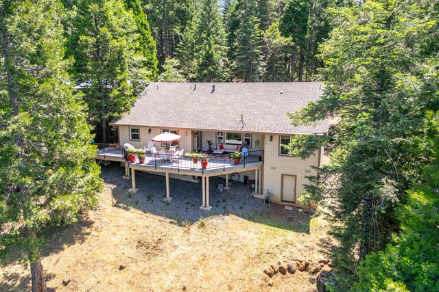 7256 Shasta Forest Dr, Shingletown, CA 96088 - rear view of house with a wooden deck, roof with shingles, and outdoor dining area