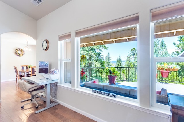 7256 Shasta Forest Dr, Shingletown, CA 96088 - office featuring arched walkways, wood finished floors, baseboards, and plenty of natural light
