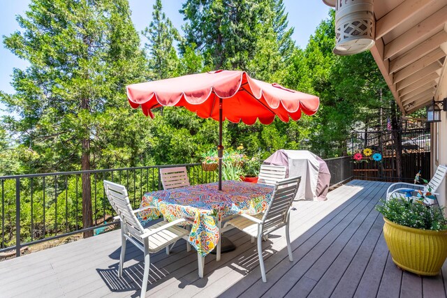 7256 Shasta Forest Dr, Shingletown, CA 96088 - deck with outdoor dining area and view of scattered trees