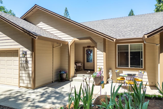7256 Shasta Forest Dr, Shingletown, CA 96088 - property entrance featuring a shingled roof and a garage