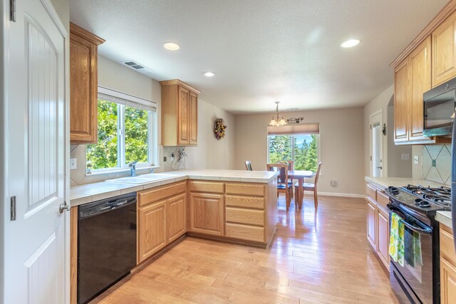7256 Shasta Forest Dr, Shingletown, CA 96088 - kitchen with black appliances, tile counters, a sink, a peninsula, and recessed lighting