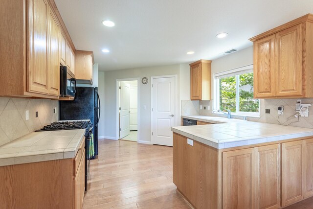 7256 Shasta Forest Dr, Shingletown, CA 96088 - kitchen featuring black appliances, a sink, tile counters, recessed lighting, and light wood-type flooring