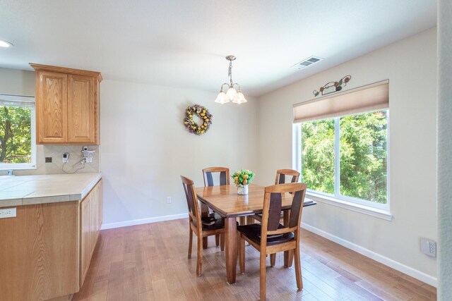 7256 Shasta Forest Dr, Shingletown, CA 96088 - dining room featuring light wood-type flooring, baseboards, a chandelier, and recessed lighting