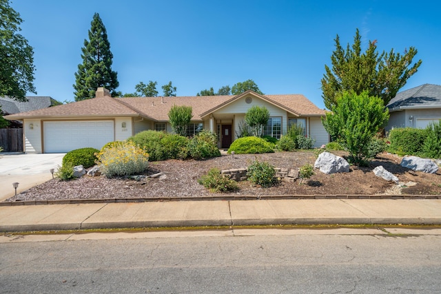 2169 Hope Ln, Redding, CA 96003 - ranch-style home with a garage, concrete driveway, and a chimney