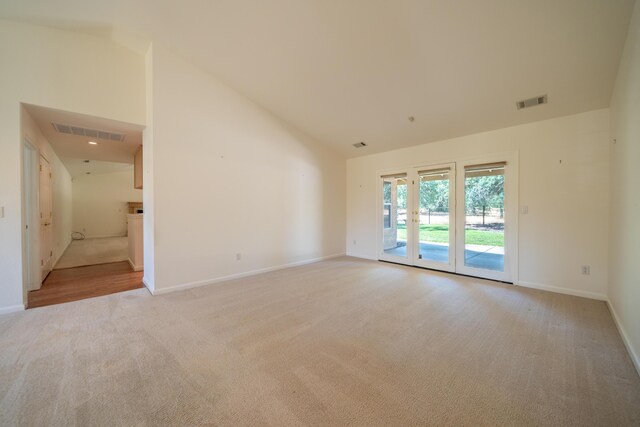 2169 Hope Ln, Redding, CA 96003 - spare room featuring light carpet, high vaulted ceiling, and baseboards