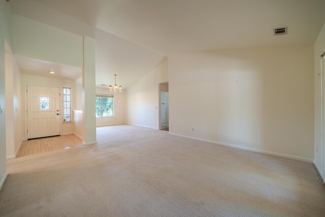 2169 Hope Ln, Redding, CA 96003 - foyer entrance featuring light carpet, a chandelier, baseboards, and lofted ceiling
