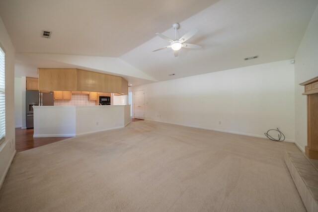 2169 Hope Ln, Redding, CA 96003 - unfurnished living room with light colored carpet, vaulted ceiling, ceiling fan, baseboards, and plenty of natural light