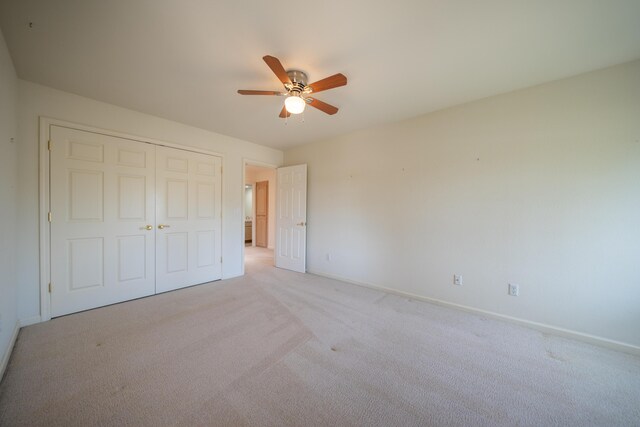 2169 Hope Ln, Redding, CA 96003 - unfurnished bedroom with baseboards, light carpet, a closet, and a ceiling fan