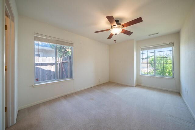 2169 Hope Ln, Redding, CA 96003 - empty room featuring healthy amount of natural light, ceiling fan, light carpet, and baseboards