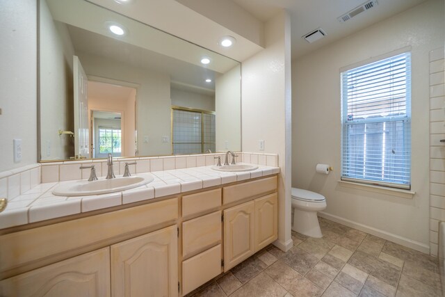 2169 Hope Ln, Redding, CA 96003 - bathroom featuring double vanity, a shower stall, toilet, recessed lighting, and baseboards