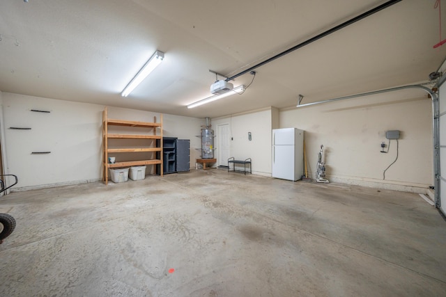2169 Hope Ln, Redding, CA 96003 - garage with freestanding refrigerator, strapped water heater, and a garage door opener
