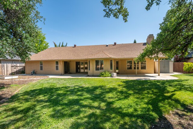 2169 Hope Ln, Redding, CA 96003 - rear view of house featuring a patio, stucco siding, a chimney, and a shed