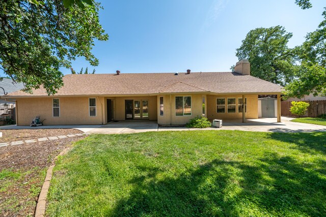 2169 Hope Ln, Redding, CA 96003 - back of house featuring a chimney, a patio area, stucco siding, and french doors