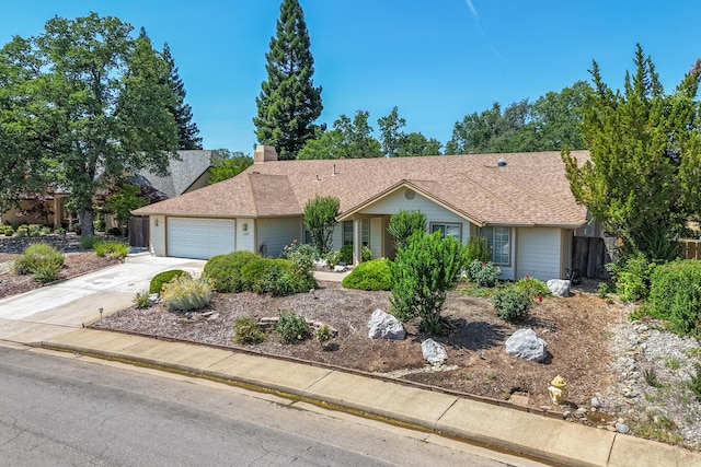 2169 Hope Ln, Redding, CA 96003 - ranch-style house with a garage, driveway, a chimney, and roof with shingles