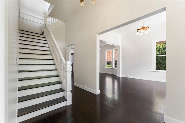 1764 Chestnut St, Redding, CA 96001 - stairway featuring a chandelier, healthy amount of natural light, hardwood / wood-style flooring, and a high ceiling