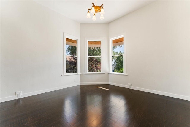 1764 Chestnut St, Redding, CA 96001 - unfurnished room with a chandelier, plenty of natural light, and dark wood-style floors