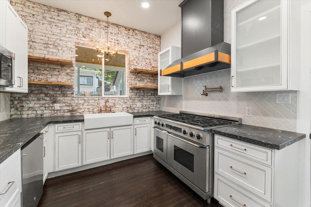 1764 Chestnut St, Redding, CA 96001 - kitchen featuring appliances with stainless steel finishes, open shelves, wall chimney exhaust hood, and a chandelier