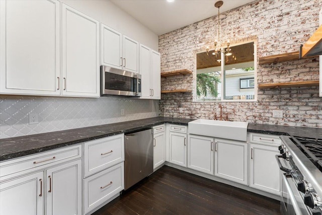 1764 Chestnut St, Redding, CA 96001 - kitchen with open shelves, appliances with stainless steel finishes, white cabinetry, and a chandelier