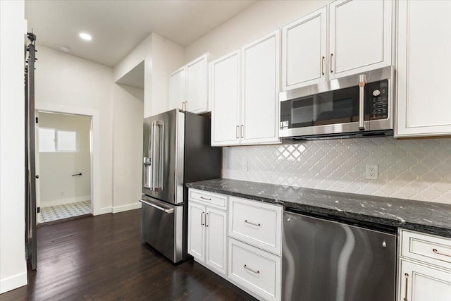 1764 Chestnut St, Redding, CA 96001 - kitchen with appliances with stainless steel finishes, tasteful backsplash, dark wood finished floors, dark stone counters, and recessed lighting