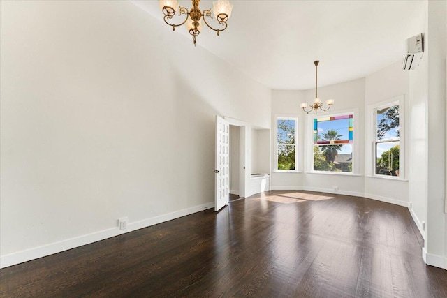 1764 Chestnut St, Redding, CA 96001 - empty room featuring a chandelier, dark wood-type flooring, and a wall mounted air conditioner
