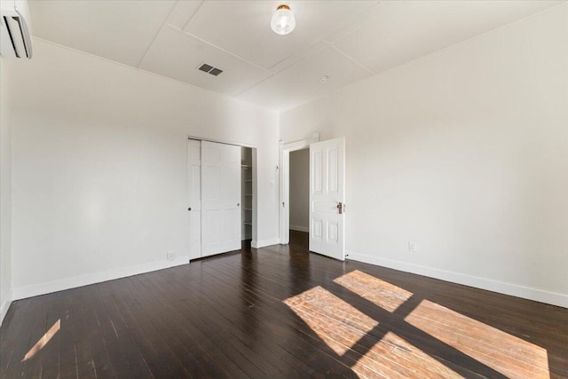 1764 Chestnut St, Redding, CA 96001 - unfurnished bedroom featuring a wall unit AC, hardwood / wood-style floors, and a closet