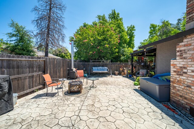 1136 Woodland Ter, Redding, CA 96002 - fenced backyard with a patio area and a fire pit