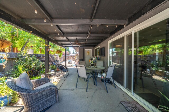 1136 Woodland Ter, Redding, CA 96002 - fenced backyard featuring a patio area, outdoor dining area, and ceiling fan
