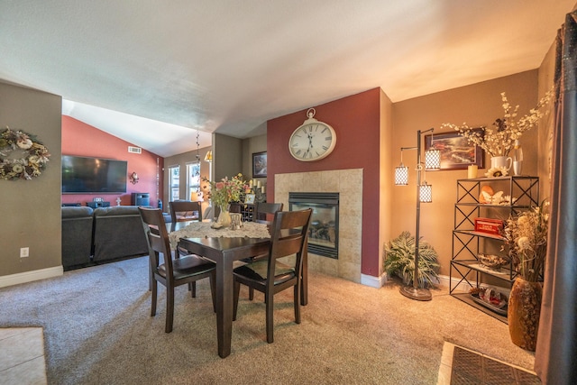 1136 Woodland Ter, Redding, CA 96002 - dining space featuring carpet, a fireplace, baseboards, and lofted ceiling