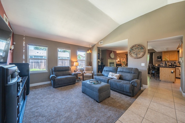1136 Woodland Ter, Redding, CA 96002 - living room featuring light tile patterned flooring, vaulted ceiling, and baseboards