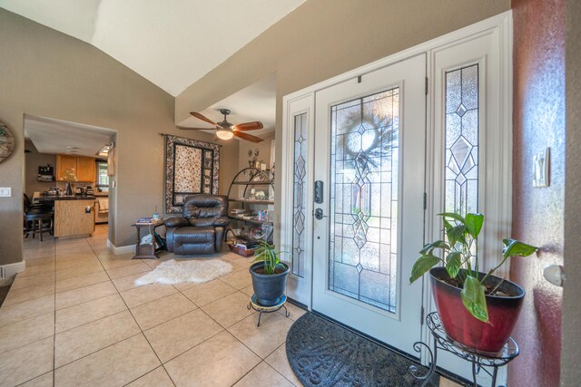 1136 Woodland Ter, Redding, CA 96002 - foyer with light tile patterned flooring, vaulted ceiling, baseboards, and a ceiling fan