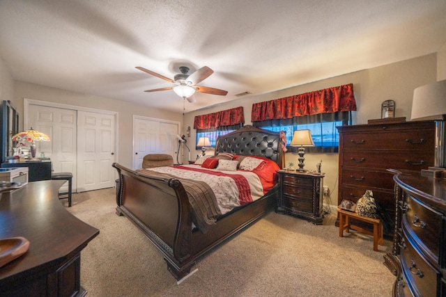 1136 Woodland Ter, Redding, CA 96002 - carpeted bedroom with two closets and a ceiling fan