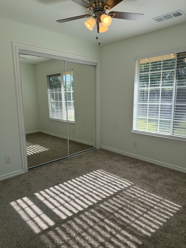 1407 Fayette Ln, Redding, CA 96003 - unfurnished bedroom featuring carpet, multiple windows, a closet, and baseboards