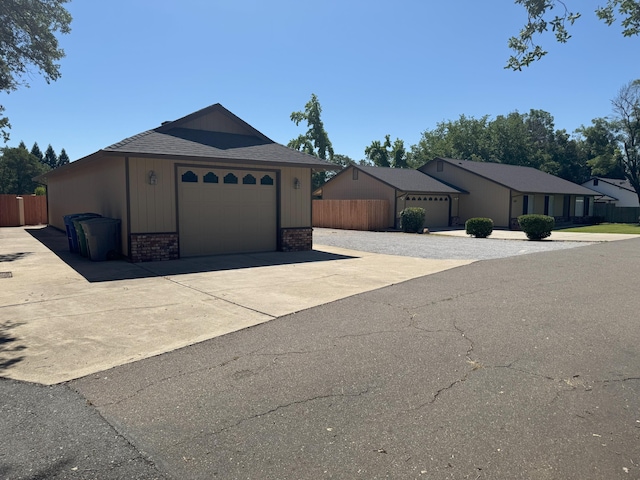 1407 Fayette Ln, Redding, CA 96003 - view of front facade featuring brick siding, a garage, and roof with shingles