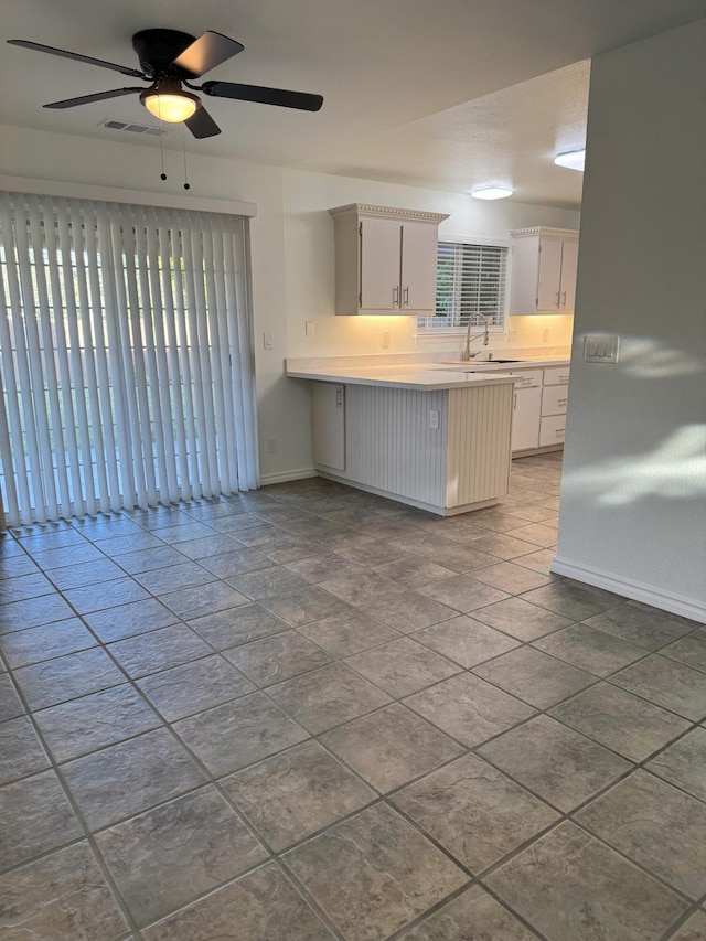 1407 Fayette Ln, Redding, CA 96003 - kitchen with a peninsula, healthy amount of natural light, baseboards, and light countertops