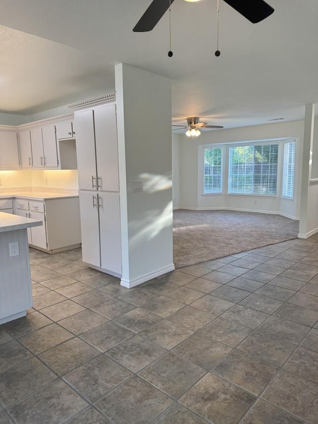 1407 Fayette Ln, Redding, CA 96003 - kitchen featuring a ceiling fan, baseboards, light countertops, and dark carpet
