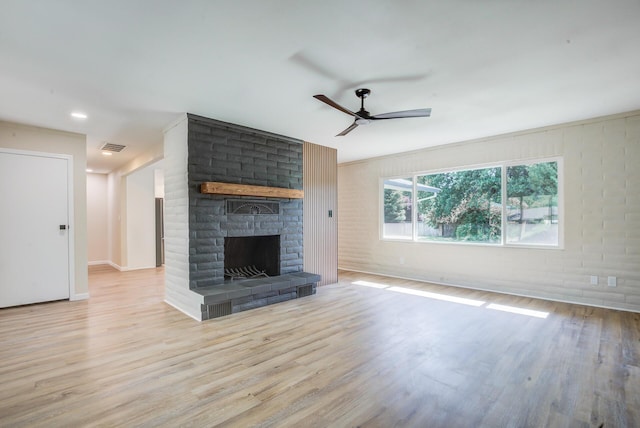 3090 Inez St, Redding, CA 96002 - unfurnished living room with wood finished floors, ceiling fan, a fireplace, and baseboards