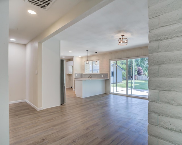 3090 Inez St, Redding, CA 96002 - unfurnished living room featuring light wood finished floors, recessed lighting, baseboards, and a sink