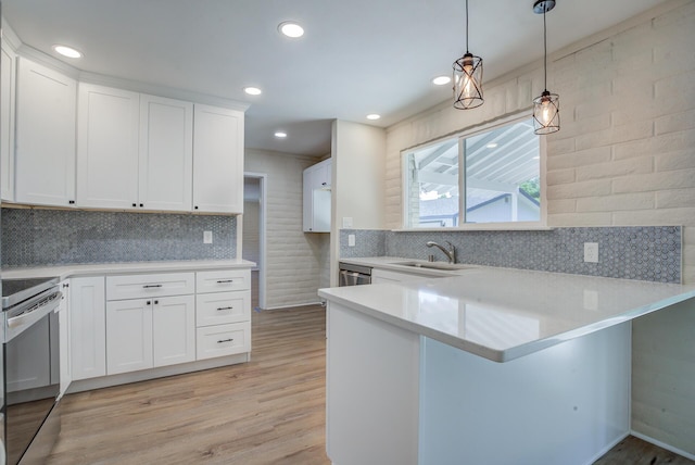 3090 Inez St, Redding, CA 96002 - kitchen featuring range with electric cooktop, a sink, a peninsula, light countertops, and recessed lighting