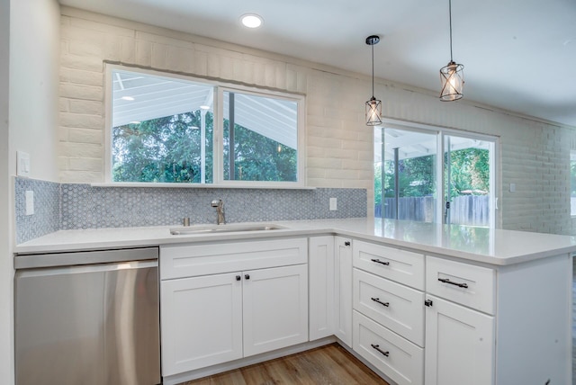3090 Inez St, Redding, CA 96002 - kitchen featuring dishwasher, a sink, light countertops, a peninsula, and white cabinets