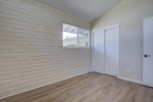 3090 Inez St, Redding, CA 96002 - unfurnished bedroom featuring vaulted ceiling, wood finished floors, baseboards, and a closet