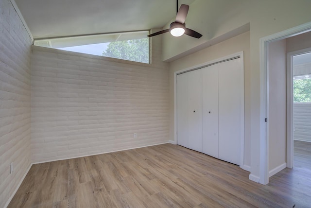 3090 Inez St, Redding, CA 96002 - unfurnished bedroom with wood finished floors, a closet, lofted ceiling, a ceiling fan, and baseboards