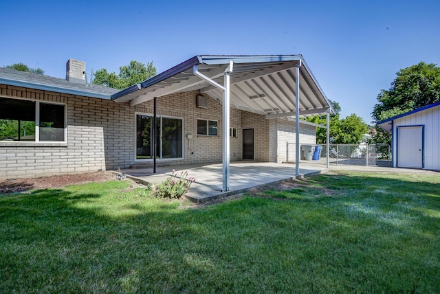 3090 Inez St, Redding, CA 96002 - rear view of house with brick siding, a patio, and a chimney