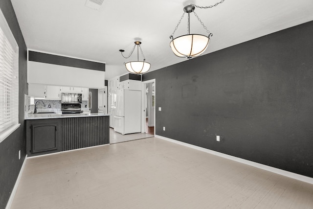 2420 Ostling Ave, Shasta Lake, CA 96019 - kitchen with black microwave, electric range, a peninsula, white fridge with ice dispenser, and light countertops