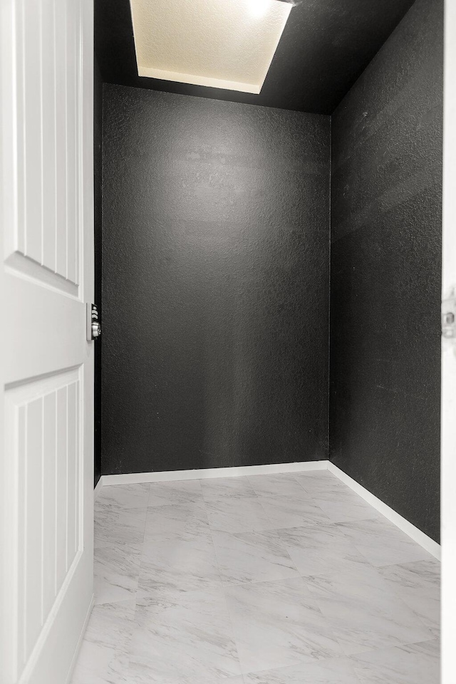 2420 Ostling Ave, Shasta Lake, CA 96019 - unfurnished room with light marble finish flooring and a textured wall