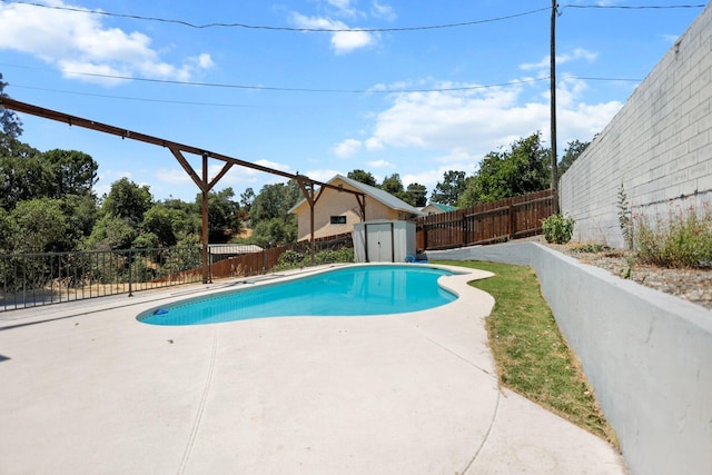2420 Ostling Ave, Shasta Lake, CA 96019 - view of swimming pool featuring a storage unit, a patio, and a fenced backyard