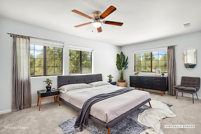 2420 Ostling Ave, Shasta Lake, CA 96019 - bedroom featuring multiple windows, light carpet, and a ceiling fan
