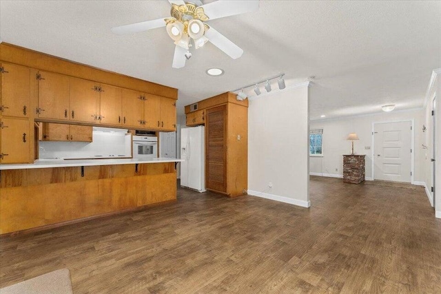 4200 Travona St, Redding, CA 96001 - kitchen with white appliances, brown cabinets, light countertops, and a ceiling fan