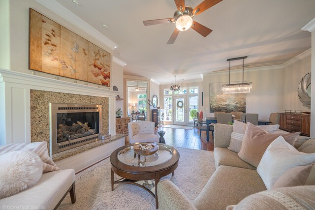 3179 Pinot Path, Redding, CA 96001 - living area featuring crown molding, ceiling fan, wood finished floors, and a high end fireplace